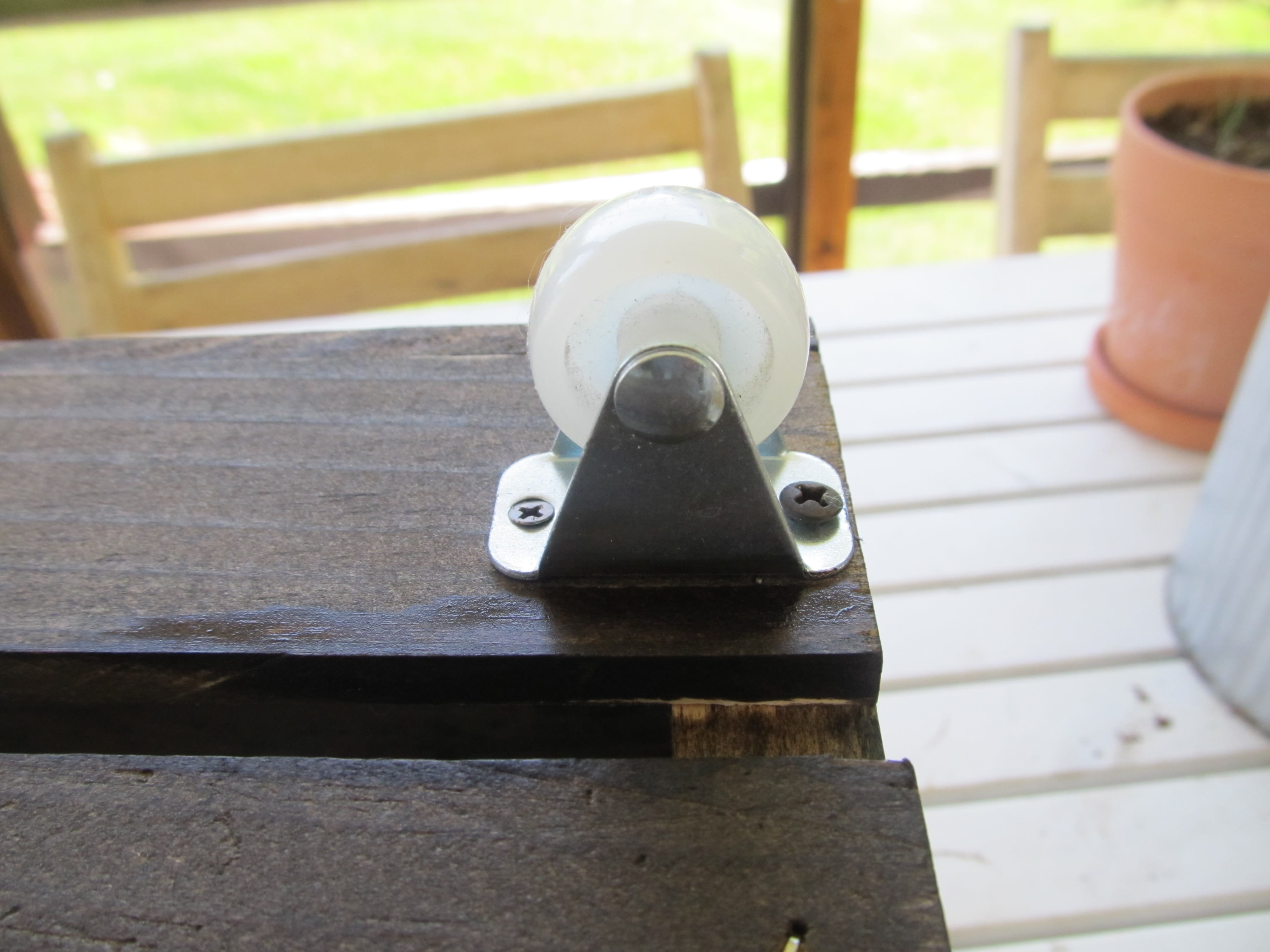 Attaching the caster wheels to the crate Joyfully Treasured