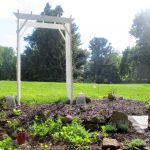 arbor anchored in garden