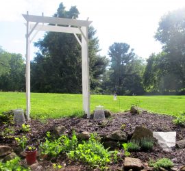 arbor anchored in garden