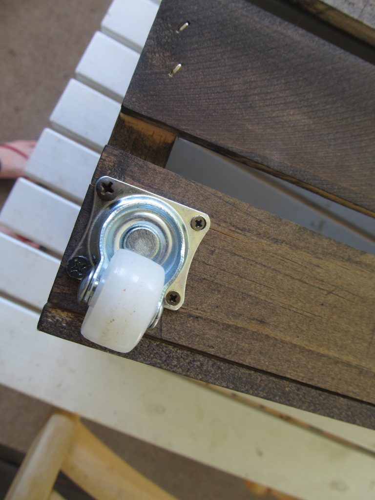 The caster wheels are attached to the crates with a screw driver