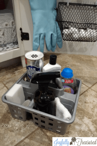 Spray painted Dollar Tree cleaning caddy from an under the kitchen sink organization makeover. Great low budget ideas to organize under the sink.
