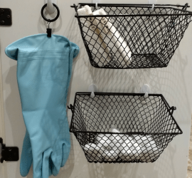 Ideas for organizing under the kitchen sink. Curtain ring clip and command hooks used to hang dish washing gloves. Command hooks and dollar tree baskets used to store sponges and dish washing tablets.