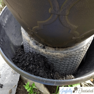 Add potting soil and flowers to the lower level to create DIY solar Fountain planter
