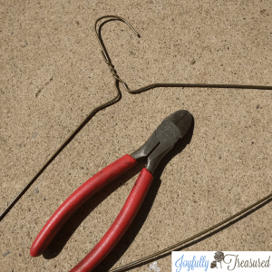 Cut a wire hanger to anchor solar fountain