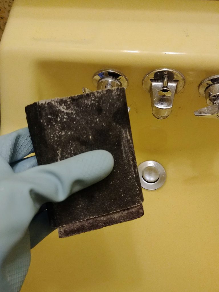 sanding the sink before painting with Rustoleum tub and tile paint kit
