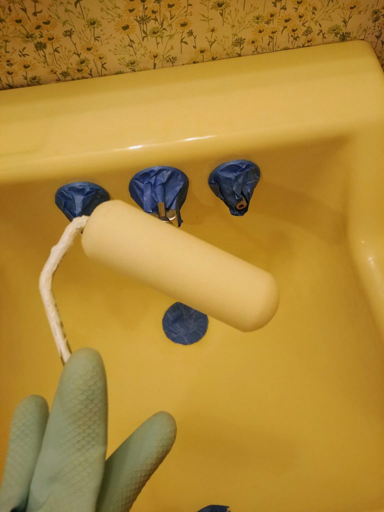 Use a high density foam roller to apply rustoleum tub and tile paint. Painting the bathroom sink white for the $100 room challenge powder room makeover