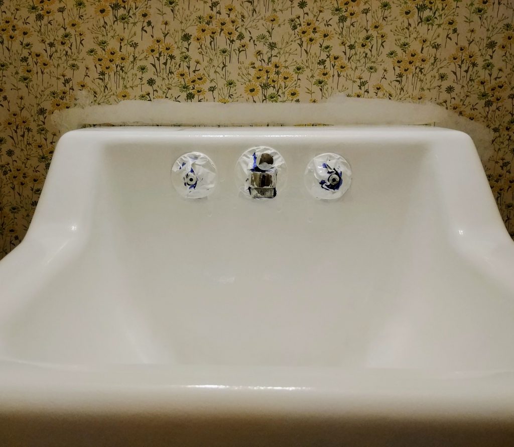 paint the bathroom sink with Rustoleum tub and tile paint, repairing drips in the finish