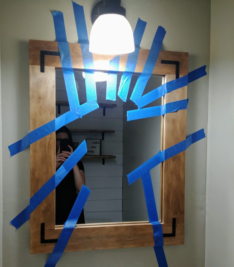 DIY framed mirror with L brackets, Industrial farmhouse bathroom mirror for a $100 bathroom makeover. We took our 1960s powder room and updated it to farmhouse style with just a $100 budget. Lots of great ideas for budget bathroom decor. #budgetdecor #homediy #bathroomdecor #farmhousedecor #farmhousestyle #bathroomideas #rustic
