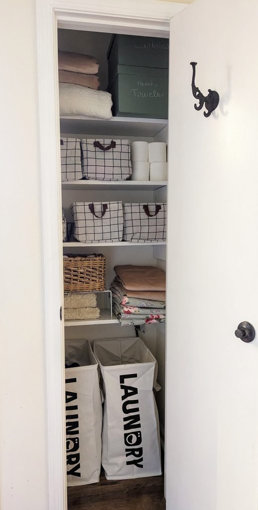 organized linen closet using Dollar Tree storage bins, baskets, and budget friendly hacks for small spaces