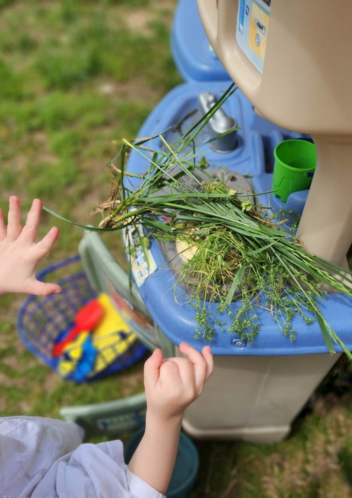 Upcycled mud kitchen made from an old plastic play kitchen, repurposed for outdoor sensory play. Easy mud kitchen ideas