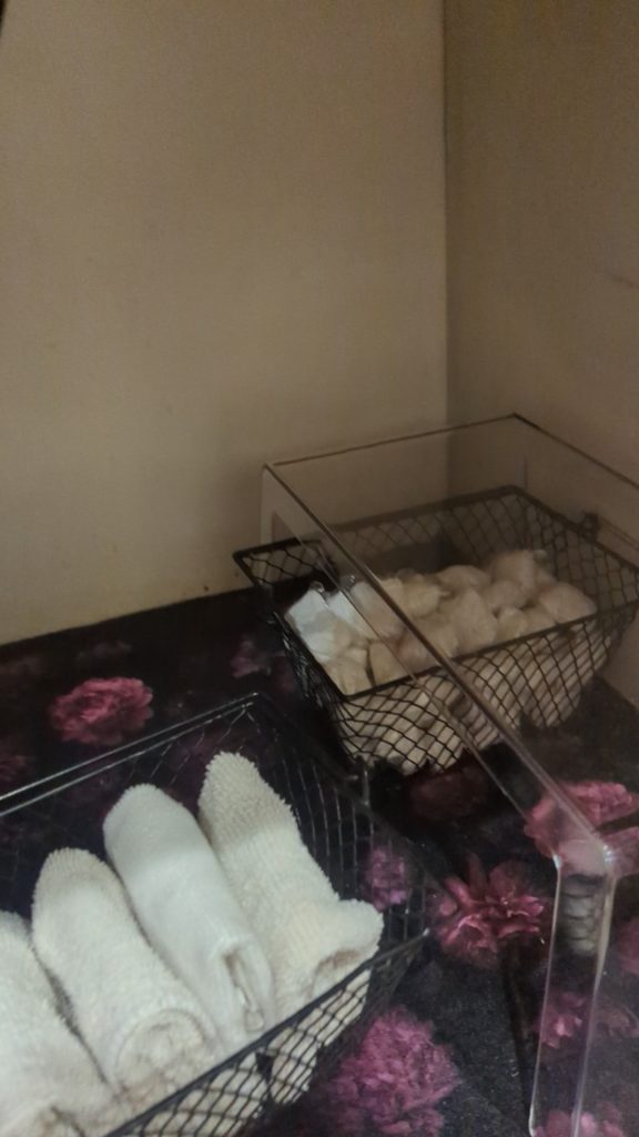 Under kitchen sink organization makeover with contact paper, shelf riser, and dollar tree baskets