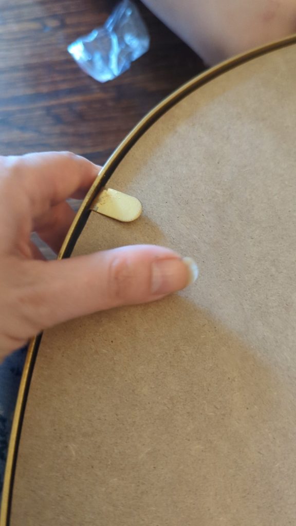 removing a broken mirror frame to upcycle a broken mirrir